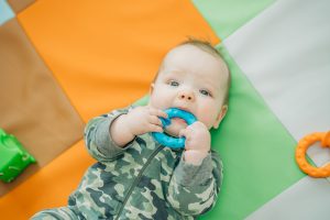 baby with teething ring at preschool