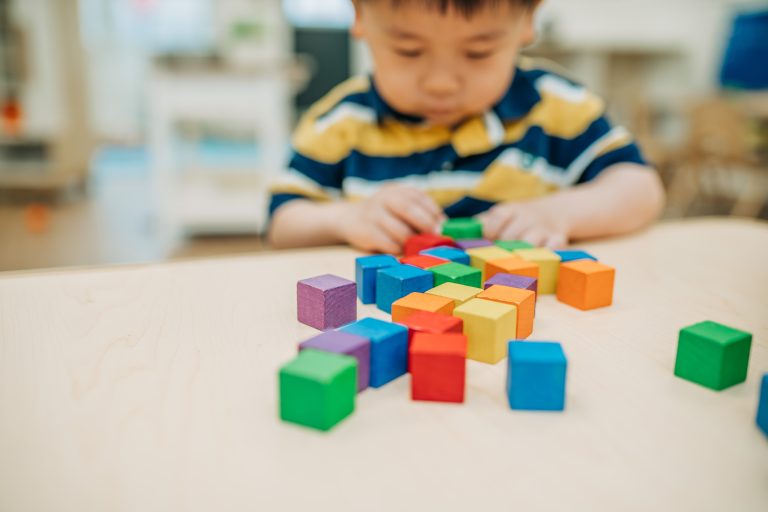 boy with blocks at preschool